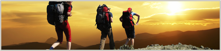 Three backpackers hike along a ridge