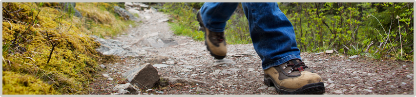 A hiker travels up a rocky trail