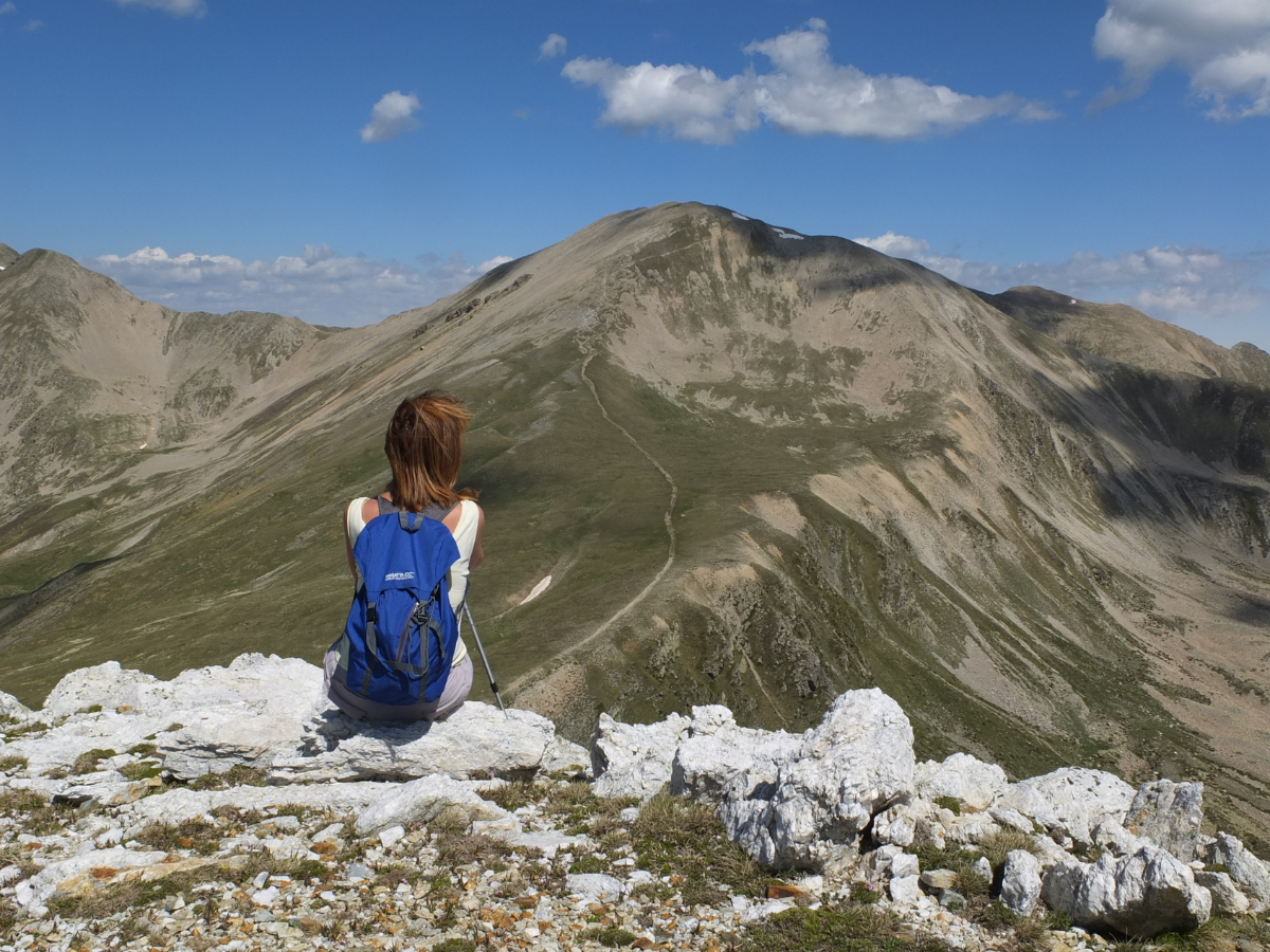 women sitting on top of a mountain